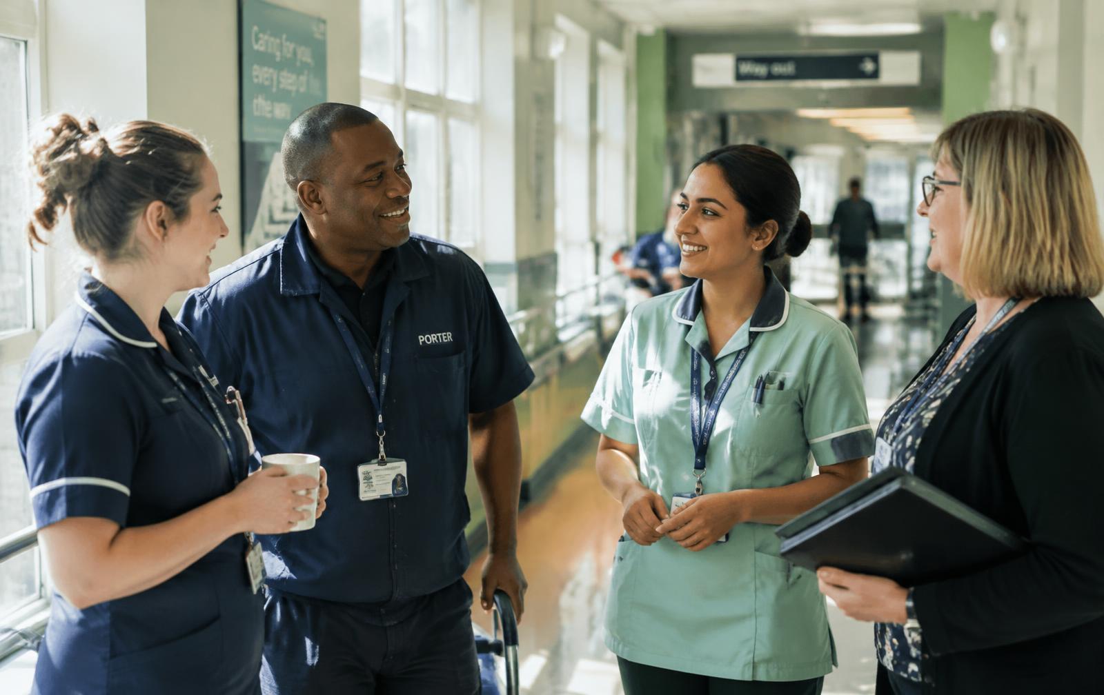 NHS staff talking in a hospital corridor